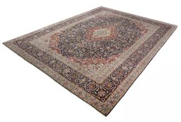 Corner detail of 2000s Kashan rug showing border pattern and Cork pile