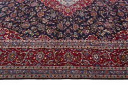 Corner detail of 2000s Kashan rug showing border pattern and Wool pile