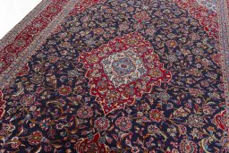 Backside of handmade 2000s Kashan rug showing knot structure and weave density