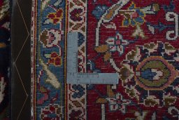 Backside of handmade 1970s Kashan rug showing knot structure and weave density