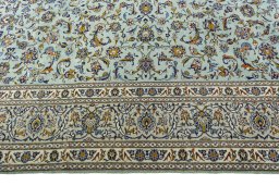 Corner detail of 2000s Kashan rug showing border pattern and Wool pile