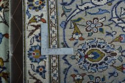 Backside of handmade 2000s Kashan rug showing knot structure and weave density