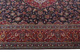 Corner detail of 2000s Kashan rug showing border pattern and Wool pile