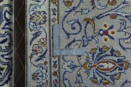 Backside of handmade 2000s Kashan rug showing knot structure and weave density