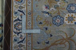 Backside of handmade 2000s Kashan rug showing knot structure and weave density