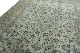 Backside of handmade 2000s Kashan rug showing knot structure and weave density