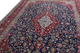 Backside of handmade 2000s Kashan rug showing knot structure and weave density