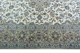Corner detail of 2000s Kashan rug showing border pattern and Wool pile