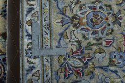 Backside of handmade 2000s Kashan rug showing knot structure and weave density