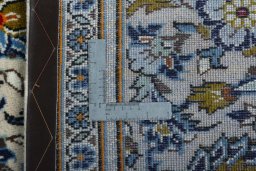 Backside of handmade 2000s Kashan rug showing knot structure and weave density