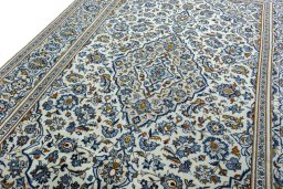 Backside of handmade 2000s Kashan rug showing knot structure and weave density
