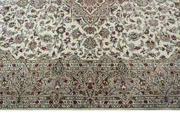Corner detail of 2000s Kashan rug showing border pattern and Wool pile