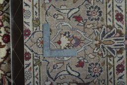Backside of handmade 2000s Kashan rug showing knot structure and weave density