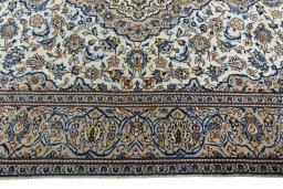 Corner detail of 2000s Kashan rug showing border pattern and Wool pile