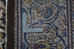 Backside of handmade 2000s Kashan rug showing knot structure and weave density
