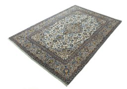 Corner detail of 2000s Kashan rug showing border pattern and Wool pile