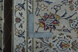 Backside of handmade 2000s Kashan rug showing knot structure and weave density