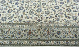 Corner detail of 2000s Kashan rug showing border pattern and Wool pile