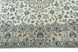 Corner detail of 2000s Kashan rug showing border pattern and Wool pile