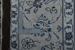 Backside of handmade 2000s Kashan rug showing knot structure and weave density