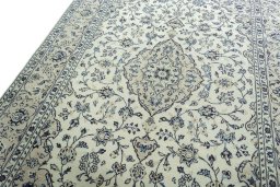 Backside of handmade 2000s Kashan rug showing knot structure and weave density