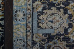 Backside of handmade 2000s Kashan rug showing knot structure and weave density