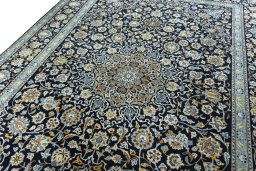 Backside of handmade 2000s Kashan rug showing knot structure and weave density