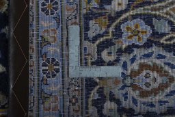 Backside of handmade 1970s Kashan rug showing knot structure and weave density