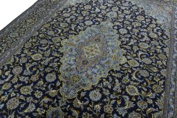 Backside of handmade 1970s Kashan rug showing knot structure and weave density