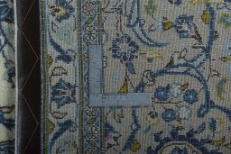 Backside of handmade 2000s Kashan rug showing knot structure and weave density