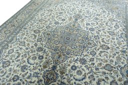 Backside of handmade 2000s Kashan rug showing knot structure and weave density