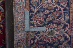 Backside of handmade 1950s Kashan rug showing knot structure and weave density