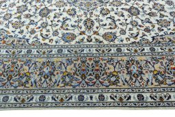 Corner detail of 2000s Kashan rug showing border pattern and Wool pile