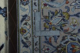 Backside of handmade 2000s Kashan rug showing knot structure and weave density