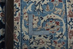 Backside of handmade 1970s Kashan rug showing knot structure and weave density