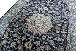 Backside of handmade 1970s Kashan rug showing knot structure and weave density