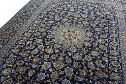 Backside of handmade 2000s Kashan rug showing knot structure and weave density