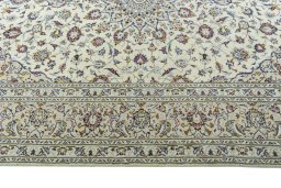 Corner detail of 2000s Kashan rug showing border pattern and Wool pile
