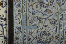Backside of handmade 2000s Kashan rug showing knot structure and weave density