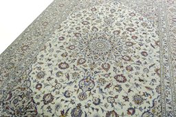 Backside of handmade 2000s Kashan rug showing knot structure and weave density
