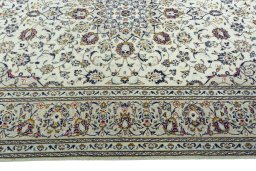 Corner detail of 2000s Kashan rug showing border pattern and Wool pile