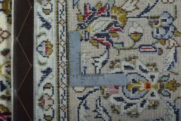 Backside of handmade 2000s Kashan rug showing knot structure and weave density
