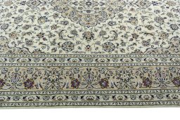 Corner detail of 2000s Kashan rug showing border pattern and Wool pile