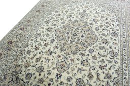 Backside of handmade 2000s Kashan rug showing knot structure and weave density