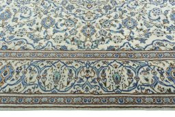 Corner detail of 2000s Kashan rug showing border pattern and Wool pile