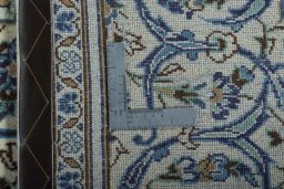 Backside of handmade 2000s Kashan rug showing knot structure and weave density