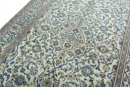 Backside of handmade 2000s Kashan rug showing knot structure and weave density