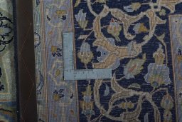 Backside of handmade 2000s Kashan rug showing knot structure and weave density