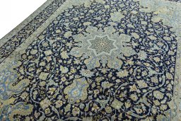Backside of handmade 2000s Kashan rug showing knot structure and weave density