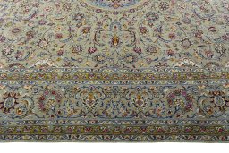 Corner detail of 2000s Kashan rug showing border pattern and Wool pile